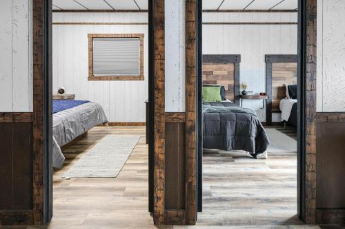 a bedroom with a bed and a mirror at Hoofbeat Haven in Sturgis