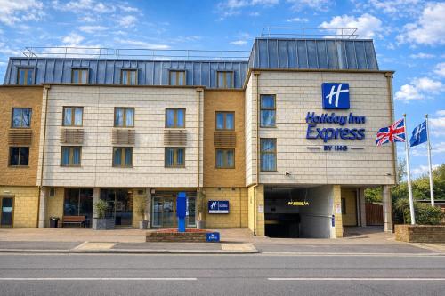 a hotel with a sign on the front of it at Holiday Inn Express Windsor by IHG in Windsor