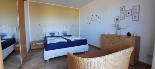 a bedroom with a bed and a chair and a mirror at Casa Panorama in La Pared