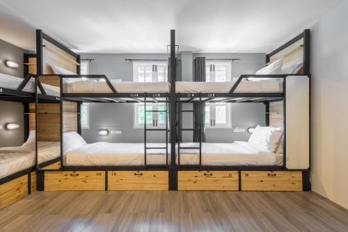 a room with three bunk beds in it at X9Hostel in Bangkok