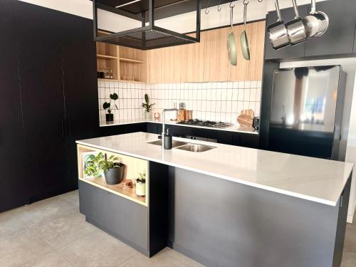 a kitchen with a sink and a counter at Stylish Industrial City Retreat in Bowden