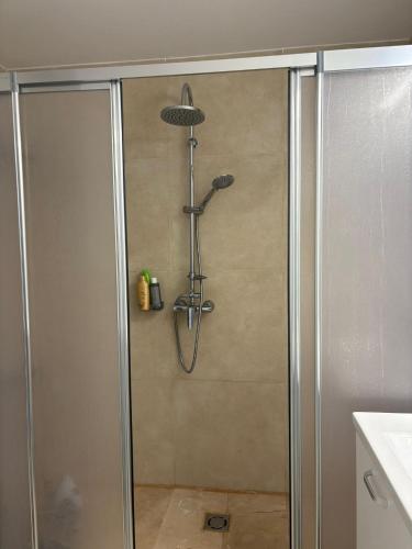 a shower with a glass door in a bathroom at BLAXY Resort STEFI in Douăzeci şi Trei August