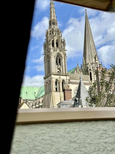 a view of a cathedral from a window at La Chapelle · Vue cathédrale · Chartres centre in Chartres