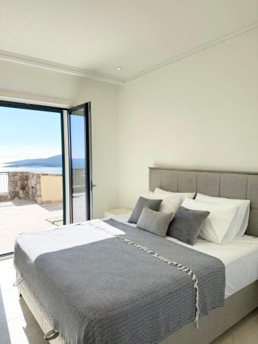 a bedroom with a large bed and a large window at Iris in Radovici