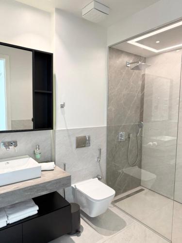 a bathroom with a shower and a toilet and a sink at Iris in Radovici