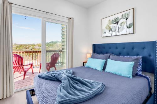 a bedroom with a blue bed and a balcony at The Container Retreat - 4B.. in Canyon Lake