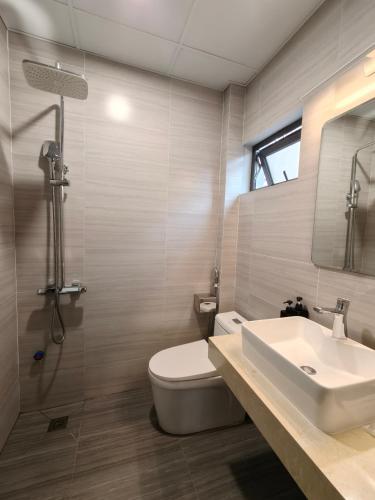 a bathroom with a white toilet and a sink at T Home Balcony in Hanoi