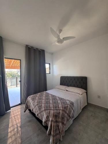 a bedroom with a bed and a ceiling fan at Casa Hospedagem e Temporada Mobiliada in Sete Lagoas