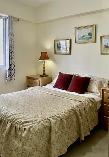 a bedroom with a large bed with red pillows at Vista Marina Boca Chica in Boca Chica