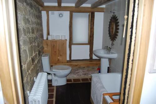 a bathroom with two toilets and a sink at Secluded 17th Century converted barn in Midhurst