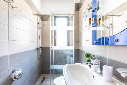 a bathroom with a sink and a glass shower at Shiny 2 Central Stay in Himare