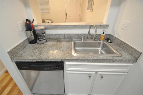 a kitchen with a sink and a counter at The Austin Cool Condo in Austin