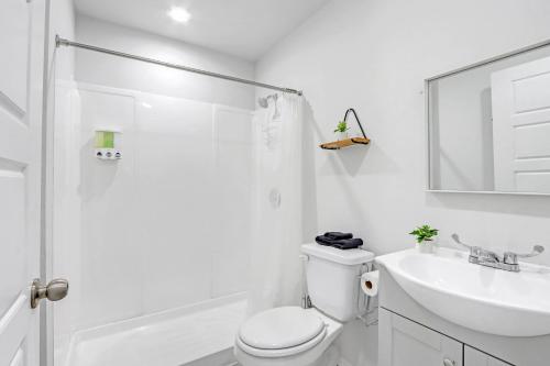 a white bathroom with a toilet and a sink at The Container Retreat - 6A.. in Canyon Lake