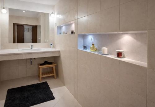 a bathroom with a sink and a mirror at Štúr Apartment Michalská in Bratislava