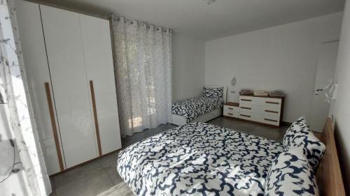 a bedroom with a bed and a dresser at La Pineta, 26 - 3 in Casarza Ligure