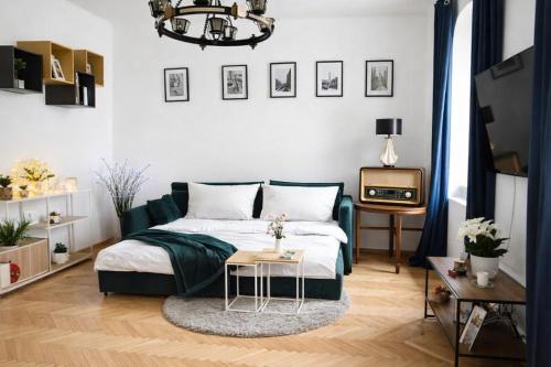 a bedroom with a bed and a tv and a table at Štúr Apartment Michalská in Bratislava