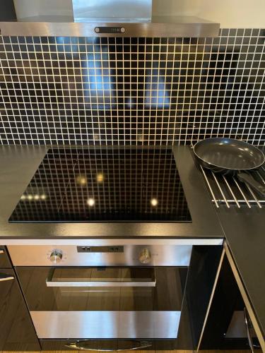 a kitchen with a black and white tiled counter top at Charming view in Olden