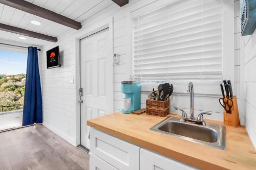 a kitchen with a sink and a window at The Container Retreat - C10 in Canyon Lake