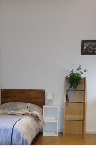 a bedroom with a bed with a wooden headboard and a shelf at Blu Mare in Punta Marina