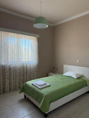 a bedroom with a bed and a large window at Anastasia's House Kos in Marmaroto