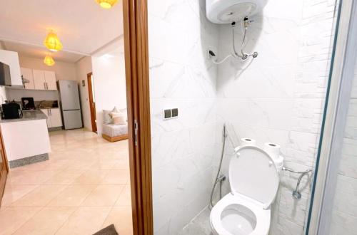 a bathroom with a toilet with a glass shower stall at Horizon bleu in El Jadida