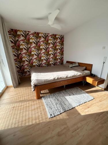 a bedroom with a bed and a wall with a mural at Cube - Ferienhaus mit Garten und Terrasse in Eberbach in Eberbach