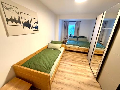 a bedroom with two beds and a mirror at Ferienwohnungen Rauch in Regen