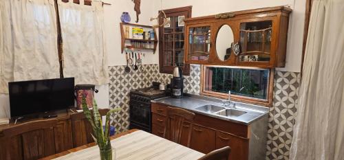 a kitchen with a sink and a counter top at Los cristales unquillo in Unquillo