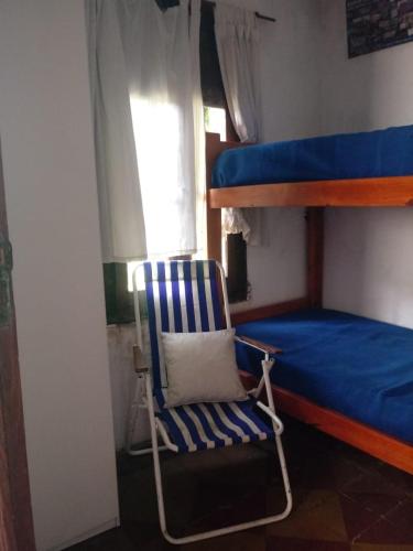 a rocking chair in a room with a bunk bed at Los cristales unquillo in Unquillo