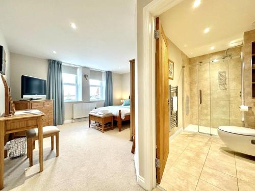 a bathroom with a toilet and a sink and a bedroom at 2 Bed in Bideford oc-73895 in Westward Ho