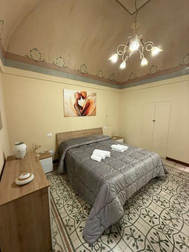 a bedroom with a bed and a table in it at Angel House in Locorotondo