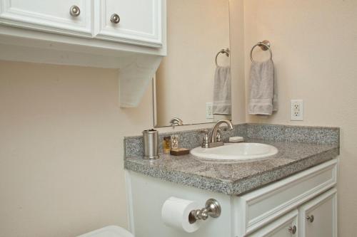 a bathroom with a sink and a mirror at Stylish Austin Condo in Austin