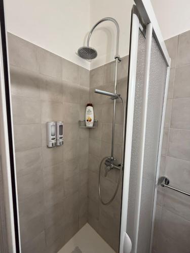 a shower with a glass door in a bathroom at Angel House in Locorotondo