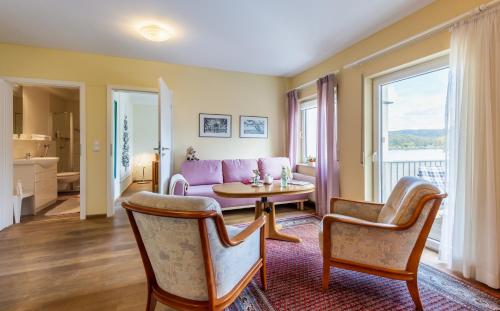 a living room with a couch and a table at Hotel Rhein-Residenz in Bad Breisig