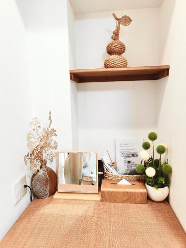 a room with plants and a mirror and a shelf at Mars Hotel in Tokyo