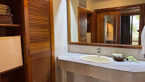 a bathroom with a sink and a mirror at Rock City Resort in Swat