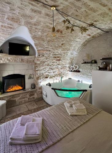 a bathroom with a tub and a fireplace at Soffio di Pietra in Castellana Grotte