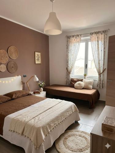 a bedroom with two beds and a window at Crisvan Home in Capo Rizzuto