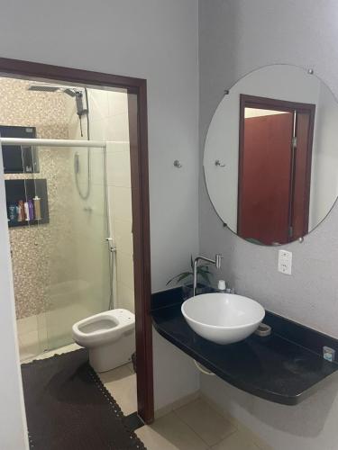 a bathroom with a sink and a toilet and a mirror at Tecnoshow in Rio Verde