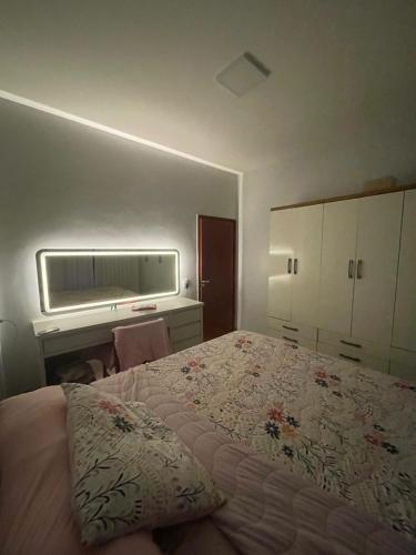a bedroom with a large bed and a desk at Tecnoshow in Rio Verde