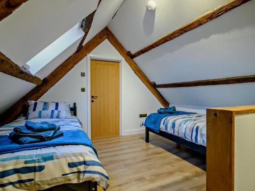 a bedroom with a bed and a wooden floor at 3 Bed in Brecon oc-93680 in Llandefalle