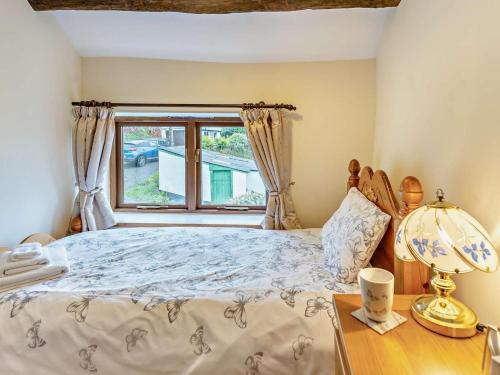 a bedroom with a bed and a window at 2 Bed in Brecon oc-bn138 in Bwlch