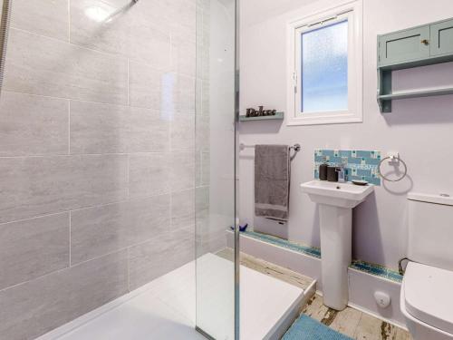 a bathroom with a shower and a toilet and a sink at 4 Bed in Bideford oc-85720 in Bideford