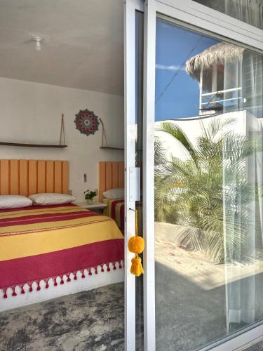 a bedroom with a bed and a sliding glass door at Casa PuntaBlanca in Puerto Ángel