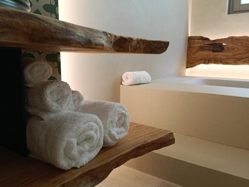 a teddy bear sitting on a bench in a room at Masseria Camerlengo in Castellana Grotte