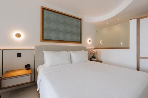 a bedroom with a large white bed and a window at Miamar in Manuel Antonio