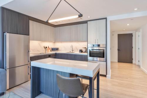 a kitchen with a large island in the middle at Seaport Retreat - Rooftop Pool & Gym in Boston