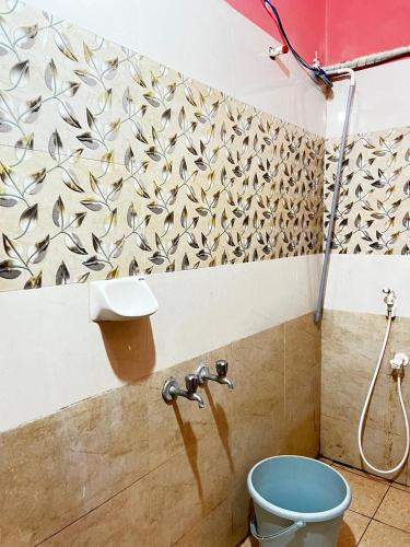 a bathroom with a blue toilet and a wall at Sri Seshadri Rest House in Avanigadda