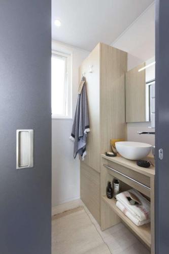 a bathroom with a sink and a white bowl at Camping Le Marqueval in Pourville-sur-Mer