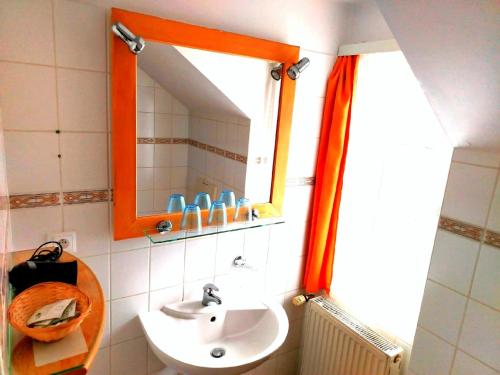 a bathroom with a sink and a mirror at Penzion Andy in Děčín